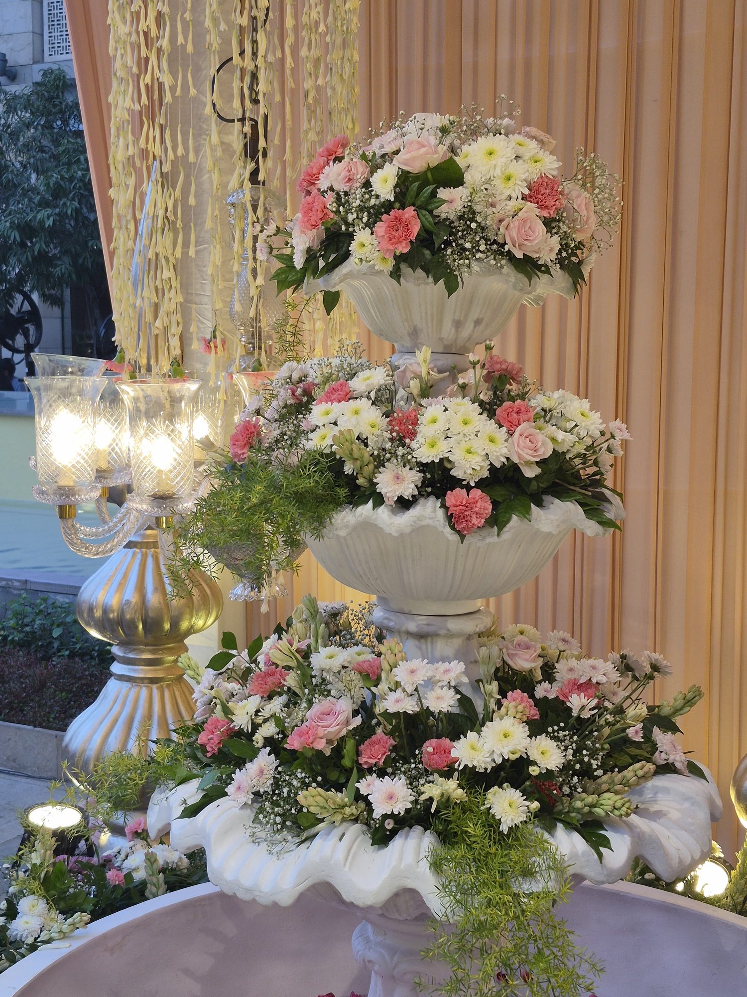 Floral urn centerpiece with candle sconces